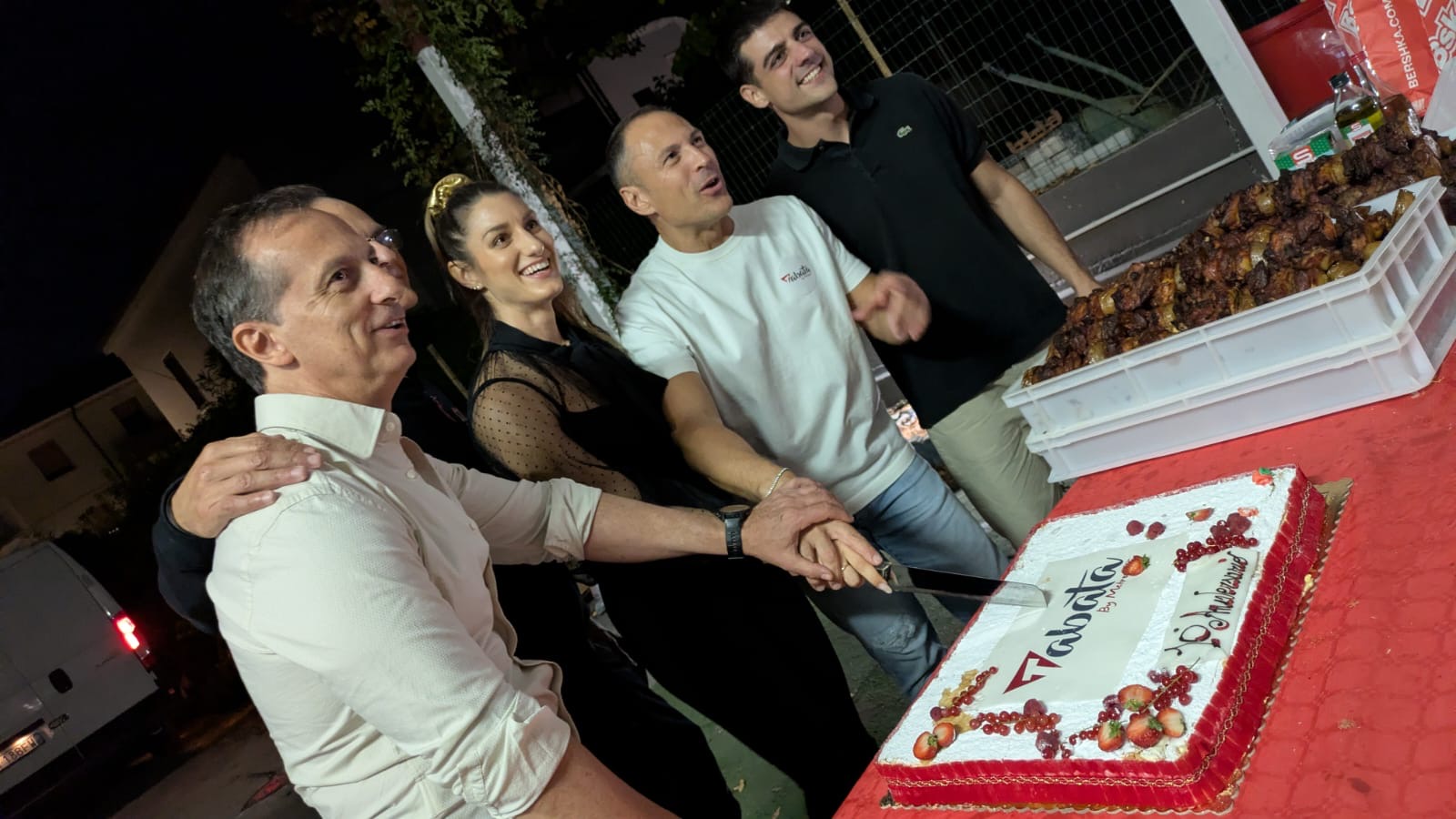 Un momento del taglio della torta, insieme allo staff